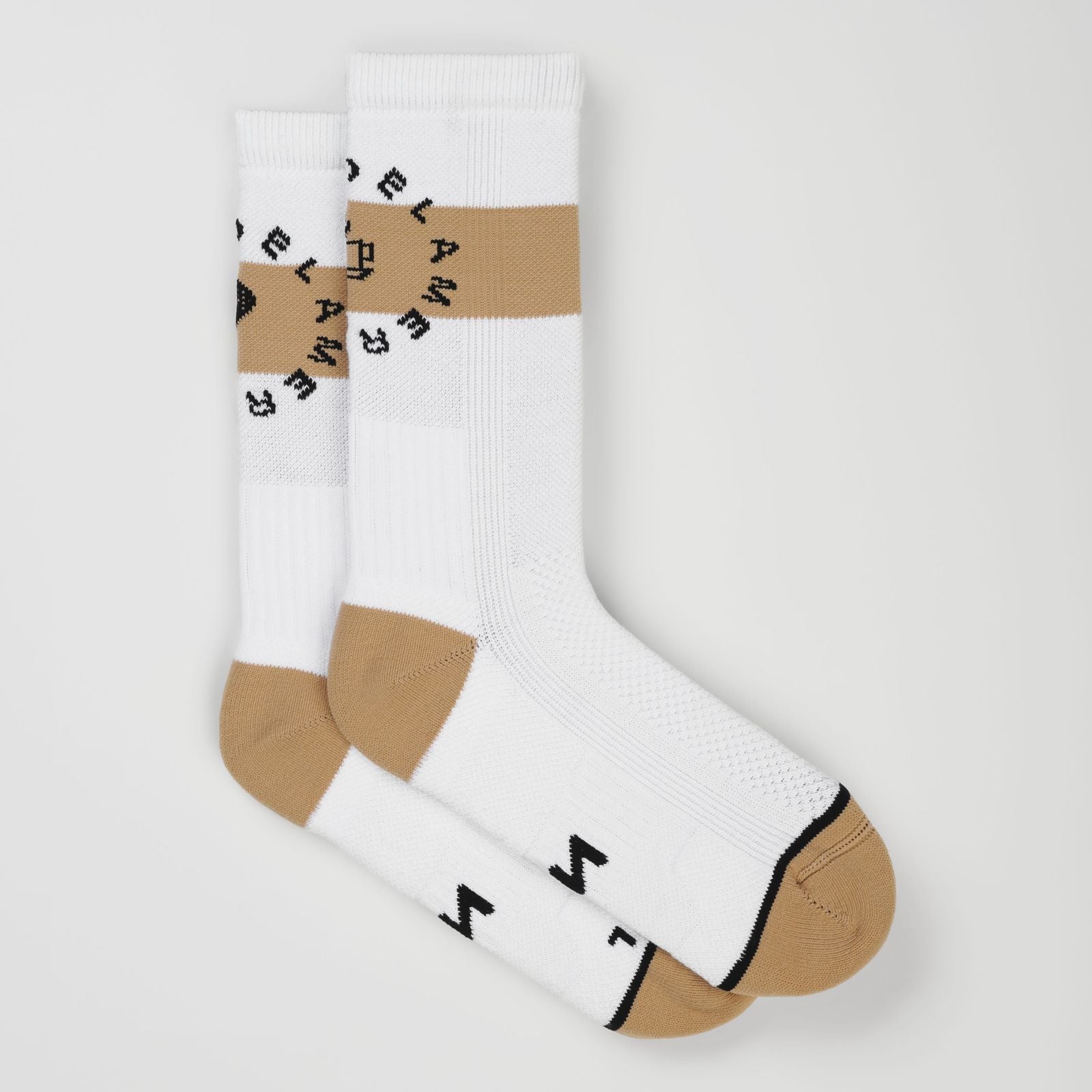A pair of white padel socks with a beige horizontal stripe across the upper leg, tan heels and toes, and black circular lettering that reads 'PADEL AMERICANO' around the stripe. One sock is laid flat, and the other is angled on top, showing a small black logo on the foot.