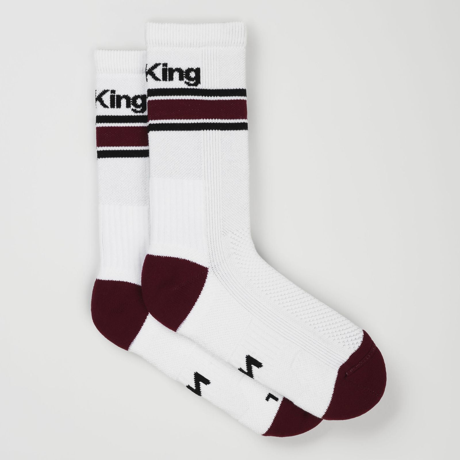 A pair of white padel tennis socks with bordeaux red toes and heels, featuring black stripes and the padel sock design name 'Net King' printed in black on the upper cuff.